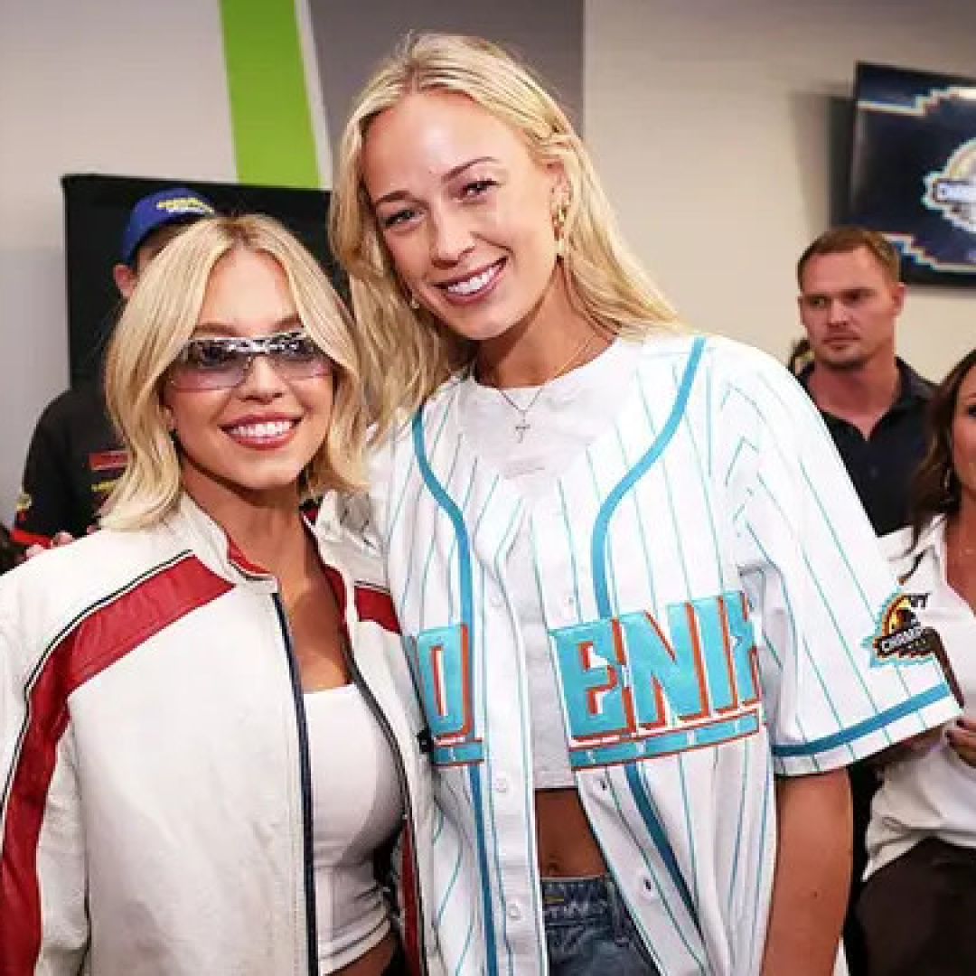 Sydney Sweeney and honorary pace car driver Sophie Cunningham pose for photos at a drivers meeting before the NASCAR Cup Series Championship at Phoenix Raceway in Avondale, Ariz., on Nov. 2, 2025.
